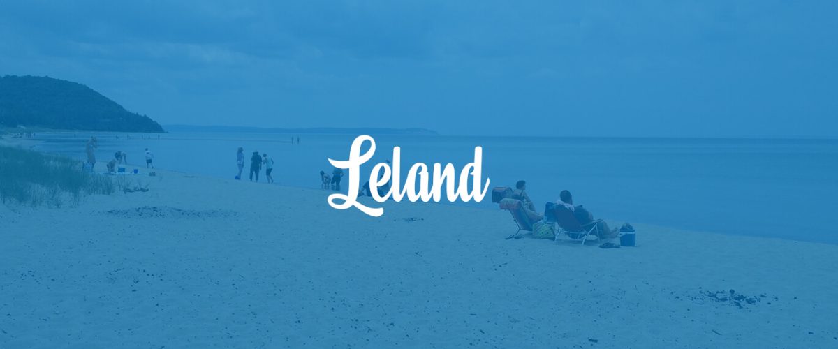A calm beach scene with people and the word 'Leland' overlaid.